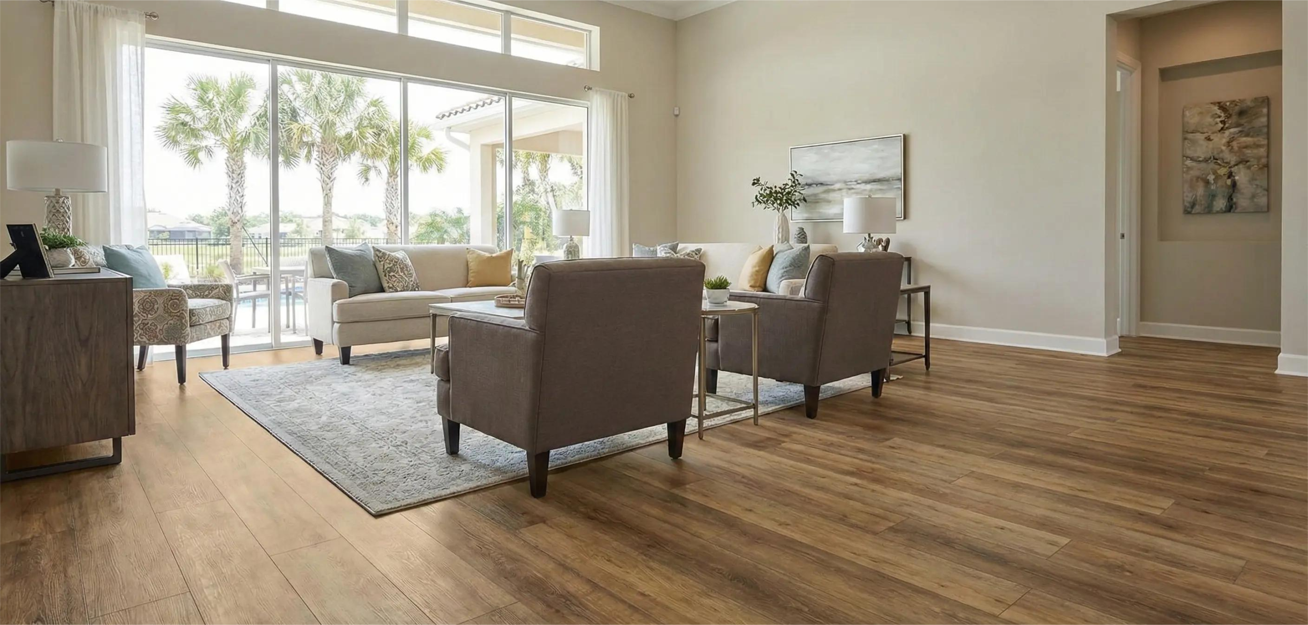 Spacious Orlando living room featuring warm oak luxury vinyl plank flooring installed with a view of Florida palm trees.